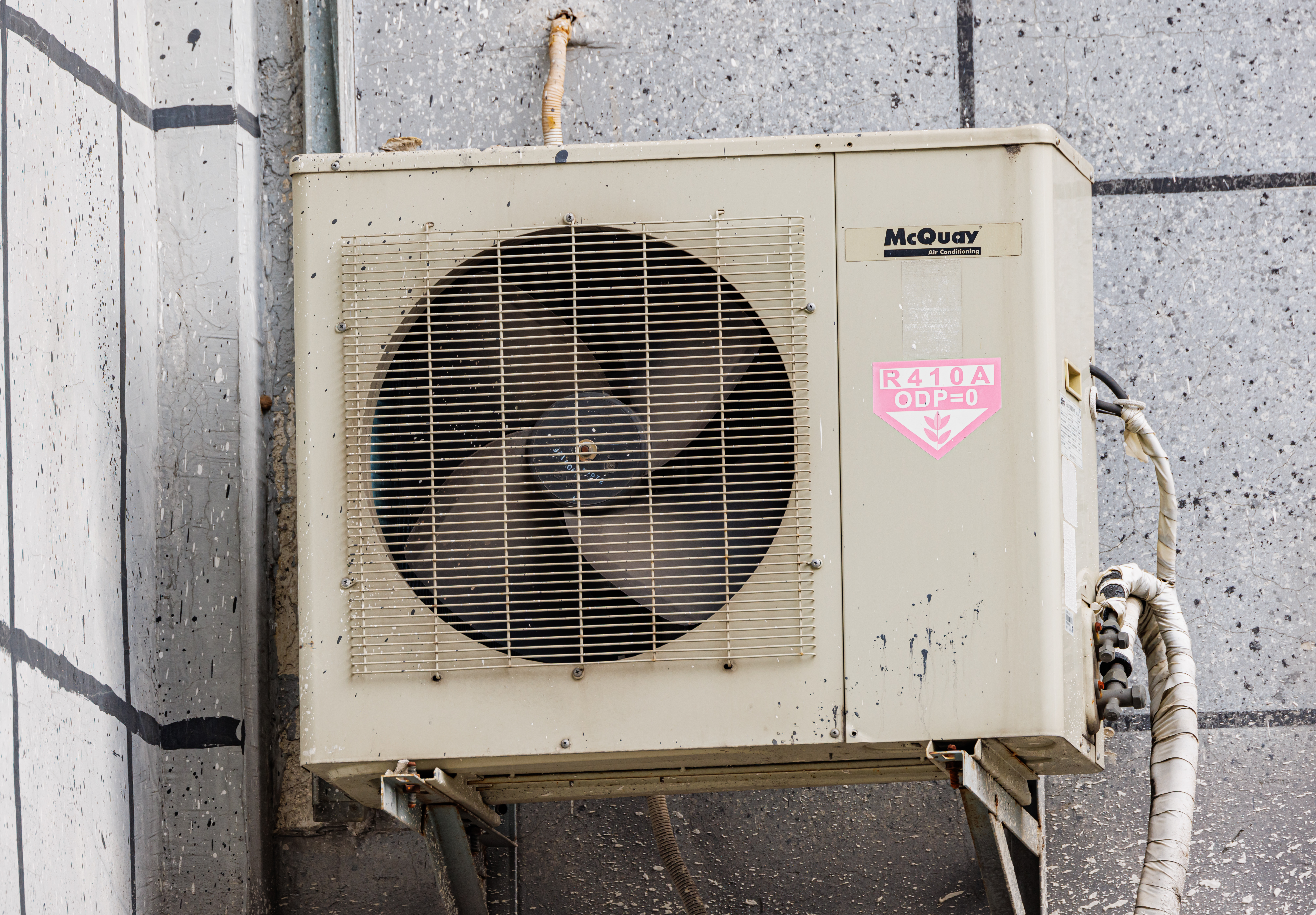 HVAC technician working on AC unit in San Angelo